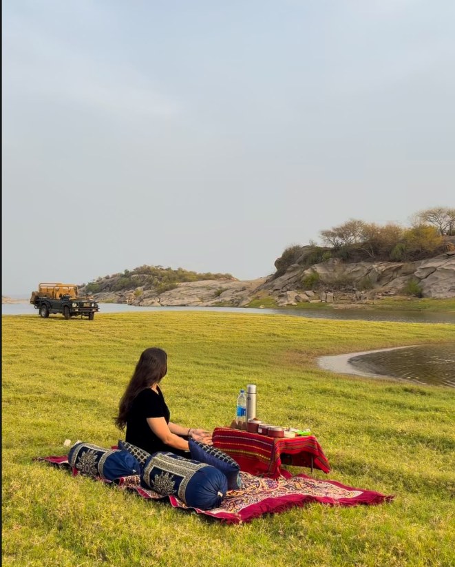 Guest enjoying a lakeside picnic setup in Jawai